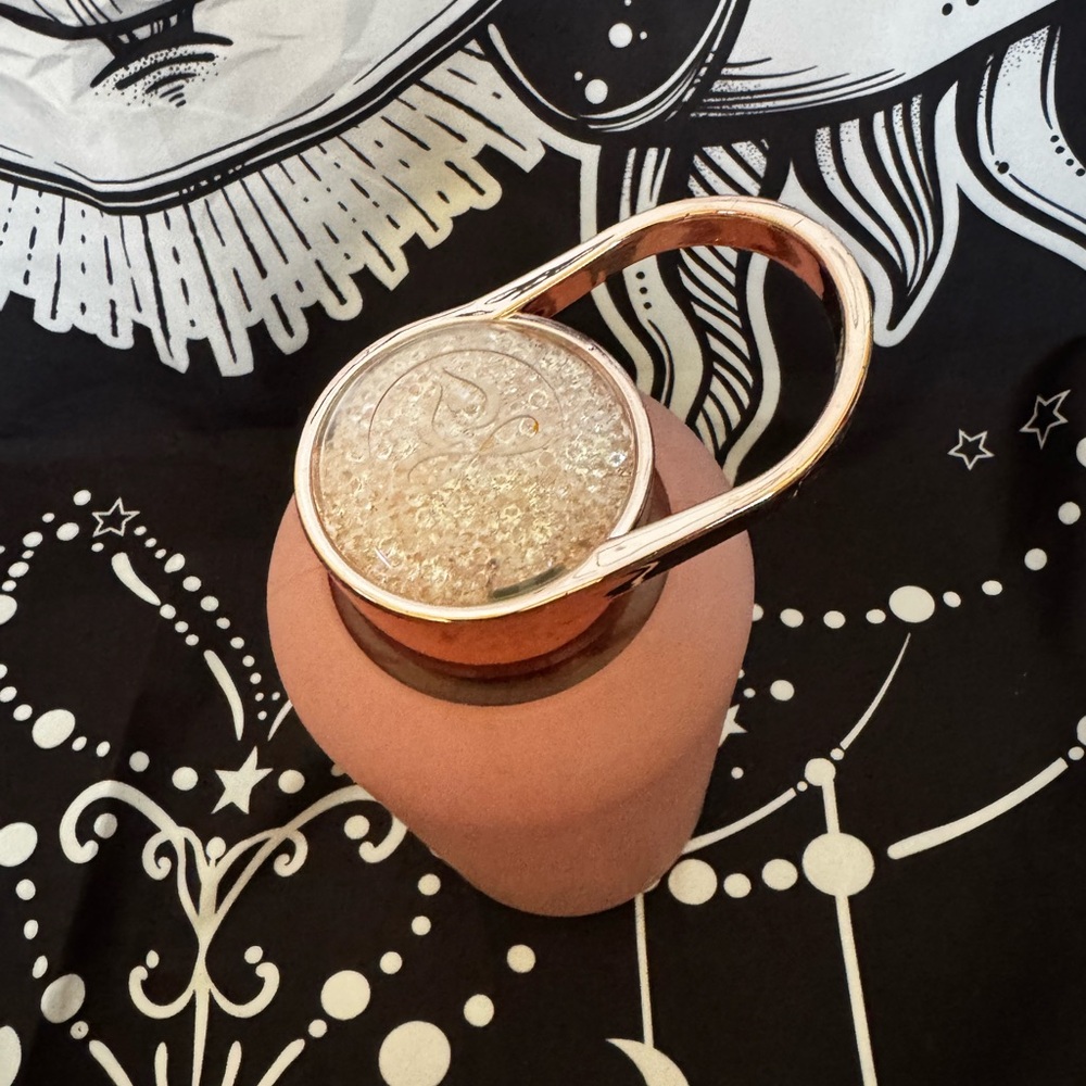 Apana rose gold glass water bottle w pink sleeve.